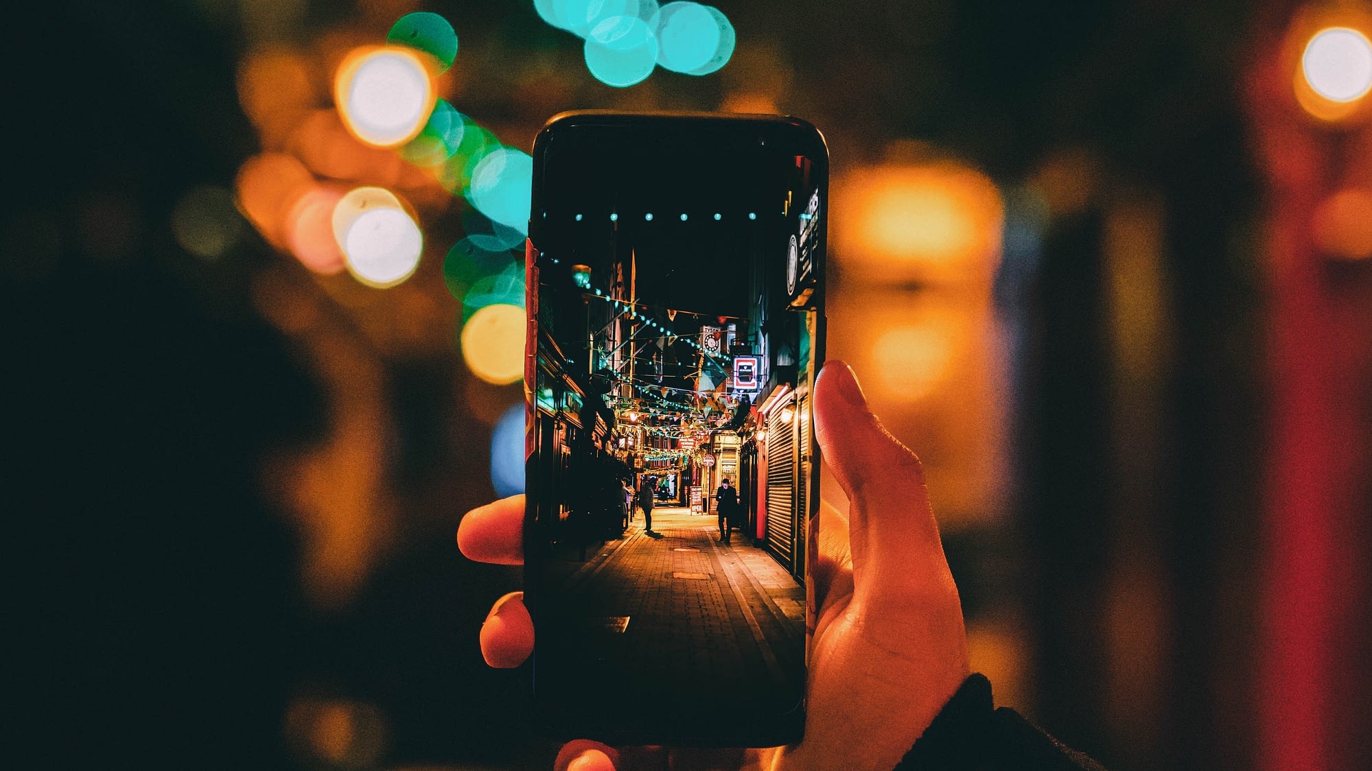 Une personne prend une photographie d'une rue avec son smartphone
